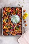 Thumbnail of traybake met krieltjes, biet, knapperige kapucijners en tzatziki | delicious.magazine